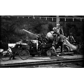 Aro Street, concrete being poured by workmen into tipper on Lister Truck