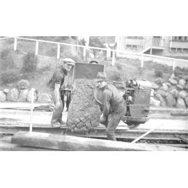 Aro Street, workmen pouring concrete out of tipper on Lister Truck, between newly laid tram rails