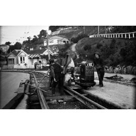 Aro Street, workmen pouring concrete out of tipper on Lister Truck, between newly laid tram rails