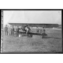 J. W. H. Scotland (standing left of Anzani engine) with his Type C Caudron biplane "Bluebird" at the Addington Showgrounds