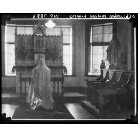 Nun praying at altar, Chapel, Calvary Hospital