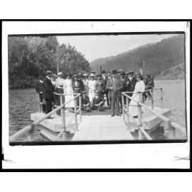 Group of people with Morton Dam in background, Wainuiomata