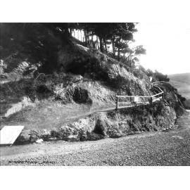 Unsealed road and access to dwelling cut into bank