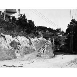 Unsealed road and access to dwelling cut into bank