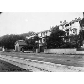 Tramtracks in road, in process of road sealing. Area of wooden dwellings