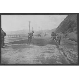 Workmen are laying new road seal on Hutt Road.