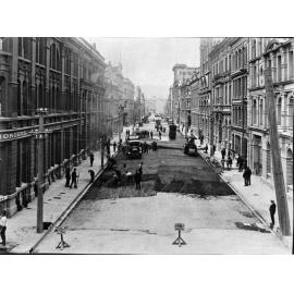 Elevated view of Victoria Street with alsphatic concrete paving in progress, number of workmen and equipment, Victoria Street, March 1926