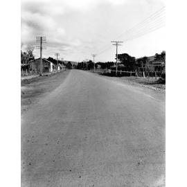 Photograph of the new alsphaltic concrete surface. A rural area with little residential development, Main Hutt Road, December 1925-June 1926