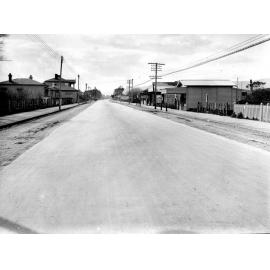 Photograph of the new alsphaltic concrete surface on High Street, previously identified as Main Hutt Road. Area of wooden dwellings and shop fronts, High Street, October 1925