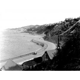 At Rata Road, dwellings on hillside and view across to Evans Bay. Photograph of the new alsphaltic concrete surface, Evans Bay Road, October 1925