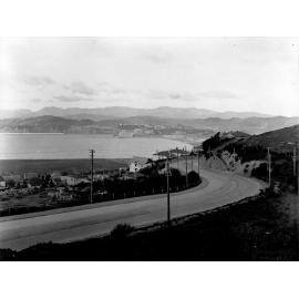 Lower end, looking across Evans Bay. Municipal Power Station on Seatoun Road [now Evans Bay Parade] in centre. Tram tracks in road, Crawford Road, March 1926
