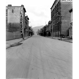 From Wakefield Street, Clarkson Motors Ltd on left. Photograph of new asphaltic concrete surface, Taranaki Street, September 1925