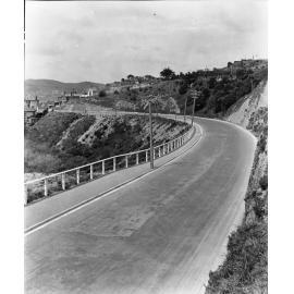 View down to towards intersection with The Terrace. Mount Street Cemetery can be seen on the right hand side. Photograph of new asphaltic concrete surface, Salamanca Road, 1926