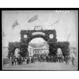 Crowd in front of a gate decorated with greenery and vegetation, Post Office Square