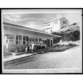 Mother and children walking past newly constructing shops, Wilton