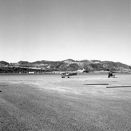 a. Drainage work at Wellington Airport. Two small aeroplanes on tarmac
