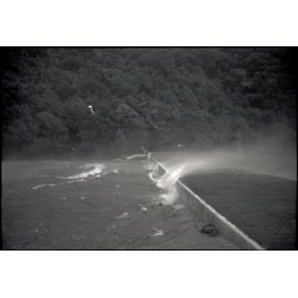 Photograph of water blowing over lower Karori dam during the Wahine storm