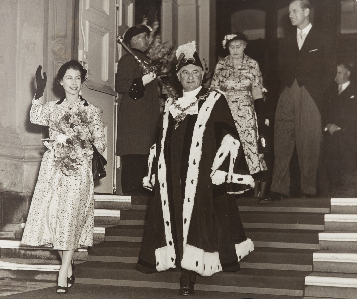 1954. Mayor, Bob McAlistair and Queen Elizabeth and the Dukes during a visit. The photo apparently hung in the Town Hall foyer. Wellington City Council Archives, AM001-20
